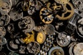 Top view of heap of metal internal parts of old clock. Dial, clockwork, bracelet, gears, cogwheels on black studio Royalty Free Stock Photo