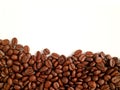 Top View of heap of roasted coffee beans on white background with free space