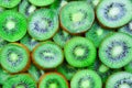 Top view of heap of sliced kiwi as textured background