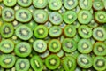 Top view of heap of sliced kiwi as textured background