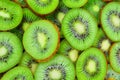 Top view of heap of sliced kiwi as textured background