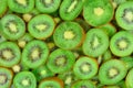 Top view of heap of sliced kiwi as textured background