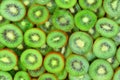 Top view of heap of sliced kiwi as textured background