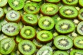 Top view of heap of sliced kiwi as textured background