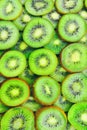 Top view of heap of sliced kiwi as textured background