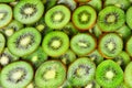 Top view of heap of sliced kiwi as textured background