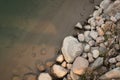 Top view of a heap of stones at the bank of the river