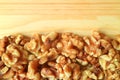 Top View of Heap of Walnut Kernels on the Wooden Table with Free Space for Text