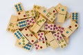 Top view of heap wooden dominoes gaming pieces on the white background