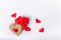 Top View heart-shaped box full of red fabric hearts on the white background. Valentine`s day background. Gathering likes
