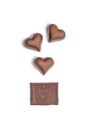 Top view of heart shaped candies and piece of chocolate bar