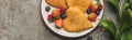 Top view of heart shaped pancakes with berries on grey concrete surface near plant, panoramic shot Royalty Free Stock Photo