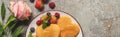 Top view of heart shaped pancakes with berries on grey concrete surface near rose, panoramic shot Royalty Free Stock Photo