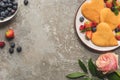 Top view of heart shaped pancakes with berries on grey concrete surface near rose Royalty Free Stock Photo