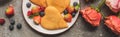 Top view of heart shaped pancakes with berries on grey concrete surface near roses, panoramic shot Royalty Free Stock Photo