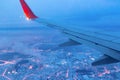 Top view from a height of flight on the night city from the window of the plane. part of an airplane wing Royalty Free Stock Photo