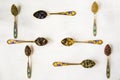 Top view of the herbal and natural dry tea variation vintage spoons on white background Royalty Free Stock Photo