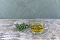 Top view Herbal rosemary tea in a glass cup on wooden vintage background. Rustic style and bunch of fresh rosemary.  Soft selected Royalty Free Stock Photo
