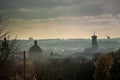 Top view from high castle on town hall and houses rooftops of old Lviv in fog Royalty Free Stock Photo