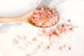 Top view of himalayan pink salt in wooden spoon on white marble table. Royalty Free Stock Photo