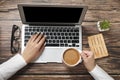 Top view of hipster wooden workspace, office table desk. Flat lay view of woman hands working on a laptop. Office work. Royalty Free Stock Photo