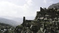 Top view of historical stone ruins on background of mountains. Action. Cinematic view of ancient stone ruins in Royalty Free Stock Photo