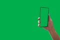 Top View holding hand smartphone with green screen Isolated on background with clipping path Royalty Free Stock Photo