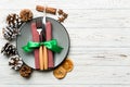 Top view of holiday dinner decorated with dried fruit and cinnamon on wooden background. Set of plate, urensil and New Year Royalty Free Stock Photo