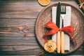 Top view of holiday dinner decorated with dried fruit and cinnamon on wooden background. Set of plate, urensil and New Year Royalty Free Stock Photo