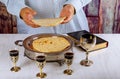 Holy communion on wooden table in church. Cup of glass with red wine, prayer for bread Royalty Free Stock Photo