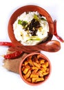 Top view of home made indian curd rice in a clay pot with fried potato