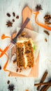 Top view of a homemade carrot cake with raisins, walnuts and cinnamon over white wooden background. Cream cheese frosting.