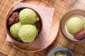 Top view of Homemade green tea or matcha ice cream in the wooden bowl with sweet red bean and put on bamboo mat Royalty Free Stock Photo