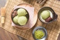 Top view of Homemade green tea or matcha ice cream in the wooden bowl with sweet red bean and put on bamboo mat Royalty Free Stock Photo