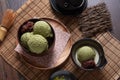 Top view of Homemade green tea or matcha ice cream in the wooden bowl with sweet red bean and put on bamboo mat Royalty Free Stock Photo