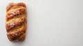 Top view of a homemade puff bun on a white tabletop. Tasty Pain au Chocolat with golden crust. Fresh bakery. Copy space. Royalty Free Stock Photo