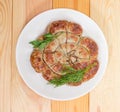 Top view of homemade sausage baked in spiral on dish Royalty Free Stock Photo