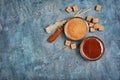 Top view on homemade sweet caramel sauce in glass bowl and brown cane sugar with sugar crystal stick Royalty Free Stock Photo