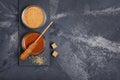 Top view on homemade sweet caramel sauce in glass bowl and brown cane sugar with sugar crystal stick Royalty Free Stock Photo