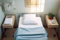 top view of a hospital bed with a white sheet, pillow, and a folded blanket