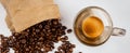 Top view of hot black fresh coffee with foam and golden cream in glass cup with roasted arabica coffee beans in burlap sack bag on Royalty Free Stock Photo