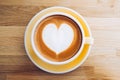 Top view of hot cappuccino coffee cup on wooden tray with heart latte art on wood table at cafe,Banner size food and drink concept Royalty Free Stock Photo