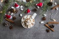 Hot chocolate cup and marshmallows against grey background with Christmas theme Royalty Free Stock Photo