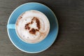 Top view of hot cocoa latte with frothed milk in ceramic cup