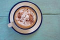 Top view of hot coffee  cappuccino cup or hot drink cocoa with milk foam and cinnamon powder on light blue pastel painted wood Royalty Free Stock Photo