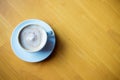 Top view of hot coffee cappuccino cup with milk foam on wood table background. Drinken latte art coffee on wooden table. Royalty Free Stock Photo