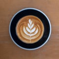 Top view hot coffee cappuccino latte art flower shape in ceramic cup selective focus Royalty Free Stock Photo