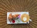 Top view of hot coffee with croissants decorate with flower Royalty Free Stock Photo