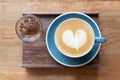 Top view of hot Coffee cup and hot tea by barista art heart shape foam on wooden table Royalty Free Stock Photo