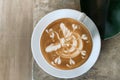 Top view of hot coffee latte cappuccino cup with abstract latte art milk foam on concrete table background with green leaf of Royalty Free Stock Photo